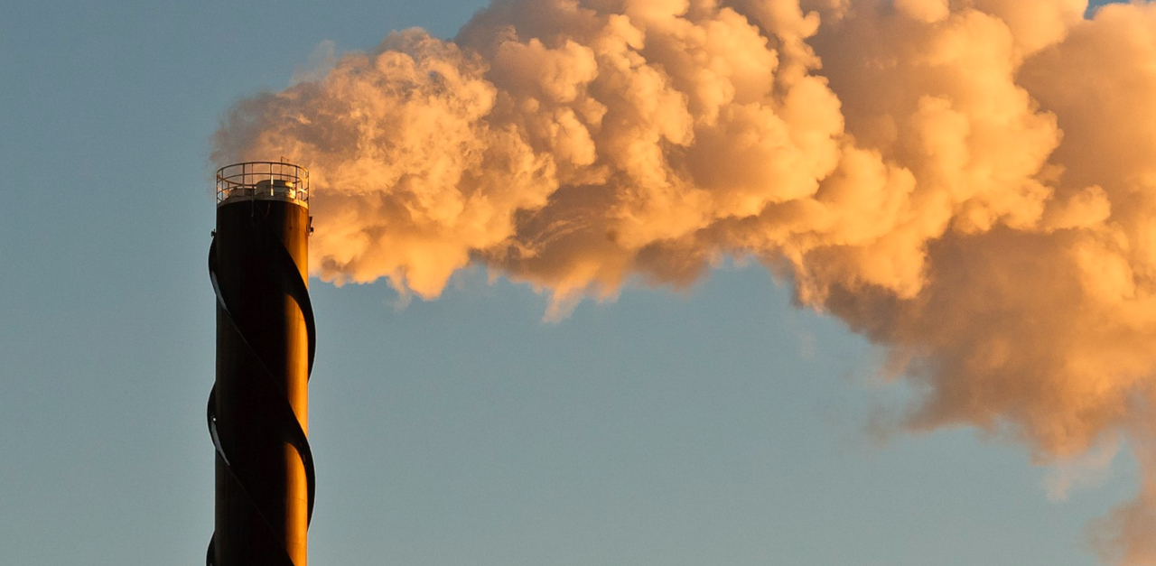 Image of smoke billowing out from a district heating plant.